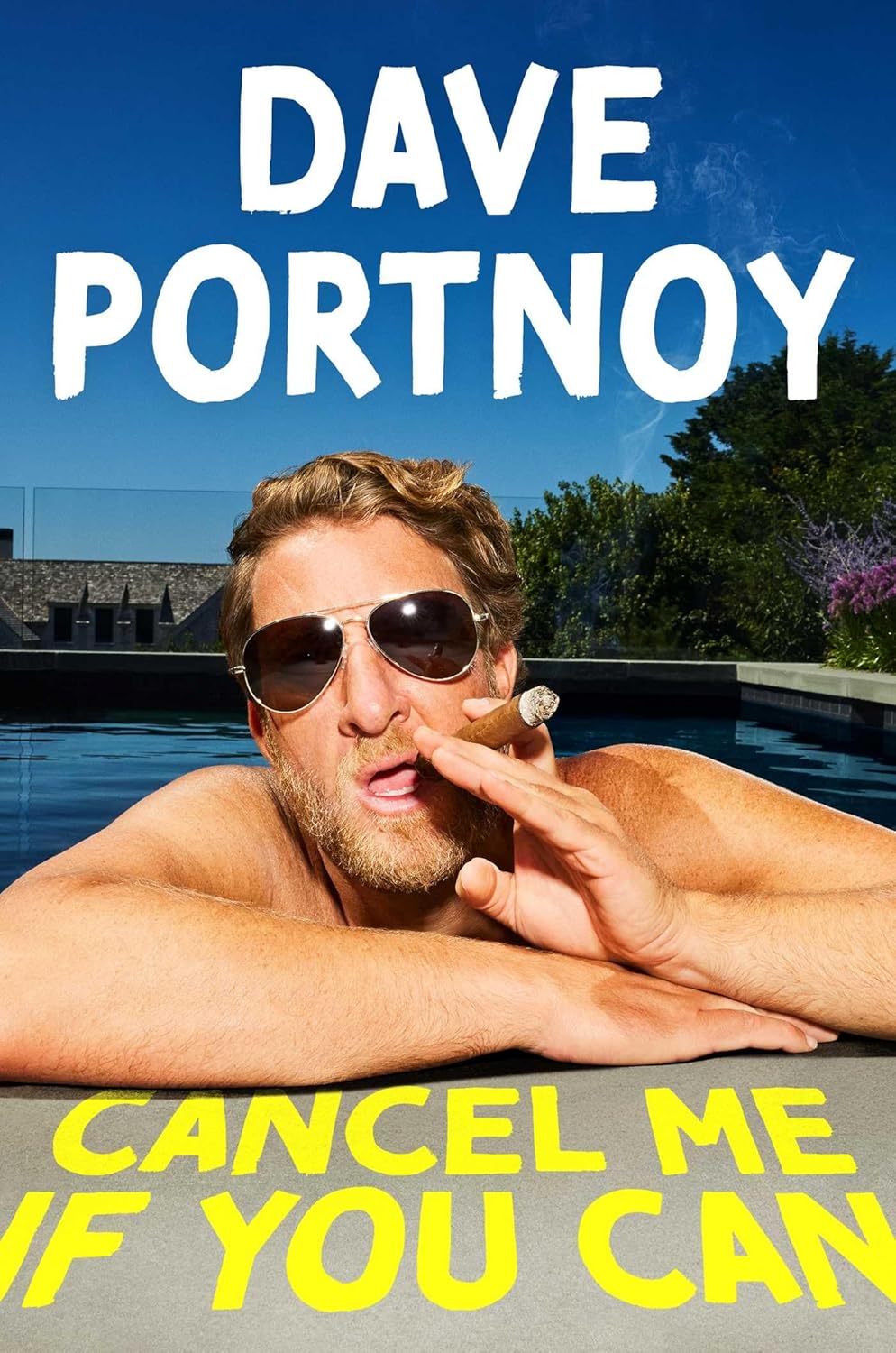 A crisp hardcover copy of Dave Portnoy's Cancel Me If You Can sitting on a rustic wooden table next to a slice of cheese pizza and a sports broadcasting microphone.